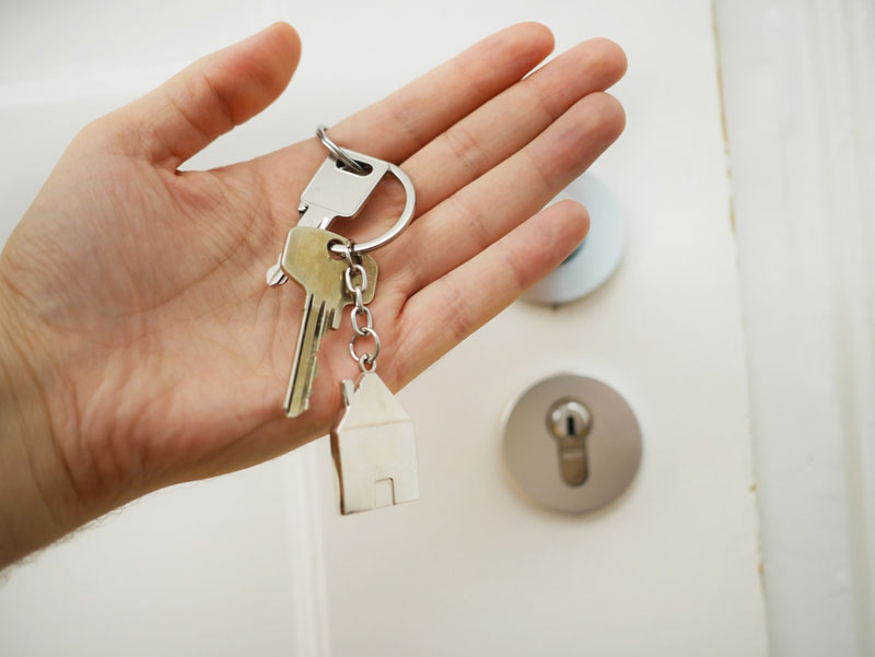 A person holding keys to their home.